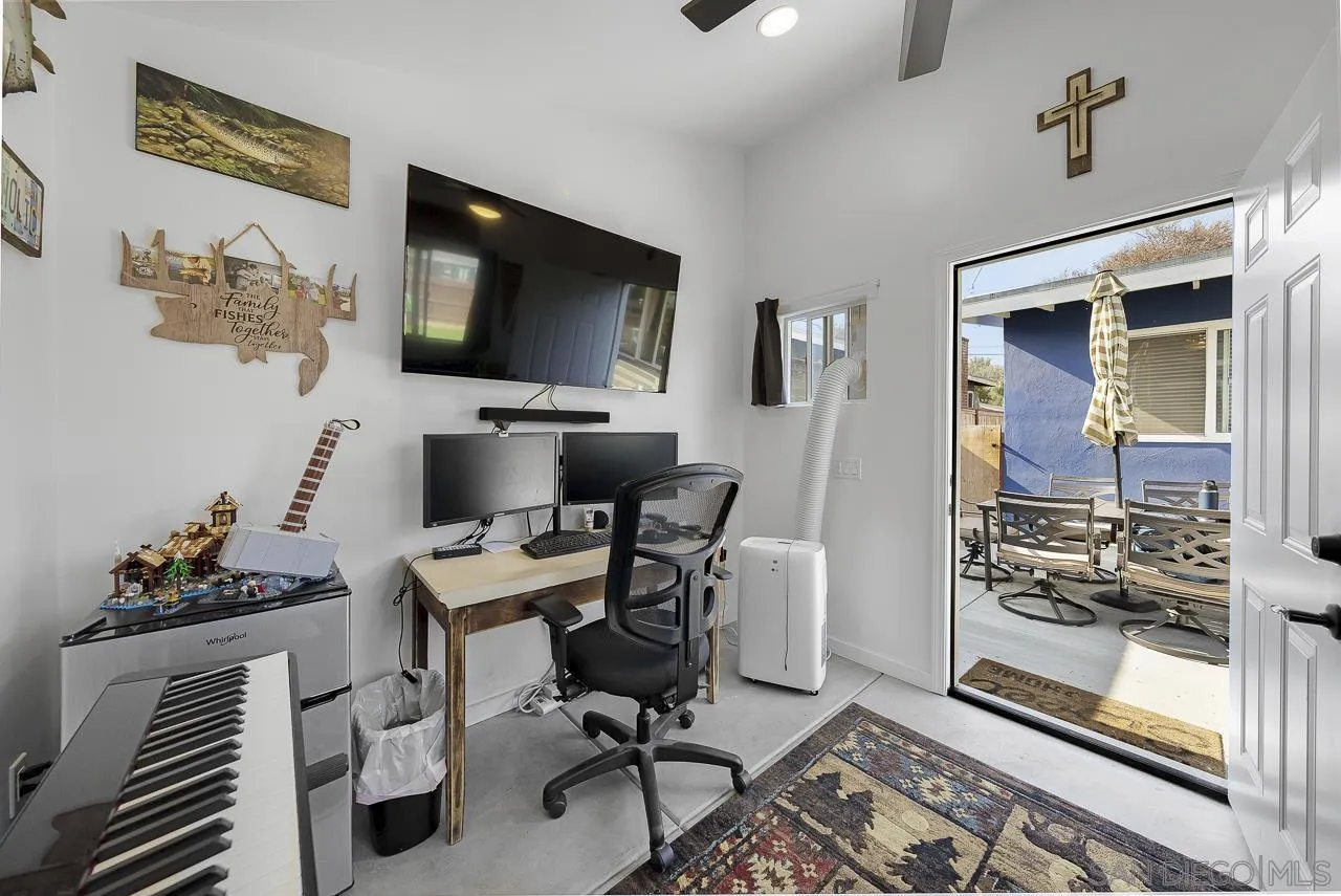 1243 Hardin Drive El Cajon, CA 92020 - Photo 26 of 32 a view of a workspace with furniture and a flat screen tv