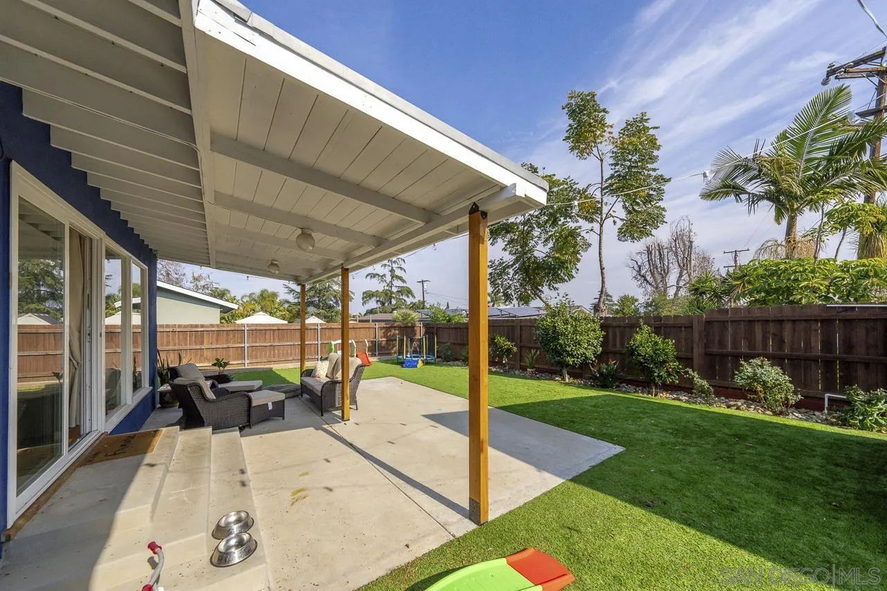 1243 Hardin Drive El Cajon, CA 92020 - Photo 28 of 32 a view of a patio with table and chairs potted plants and floor to ceiling window