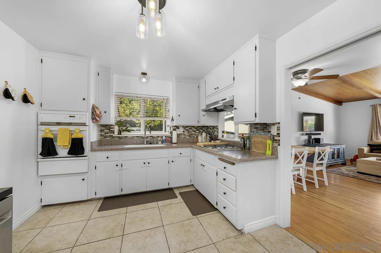 1243 Hardin Drive El Cajon, CA 92020 - Photo 8 of 32 a kitchen with cabinets and wooden floor