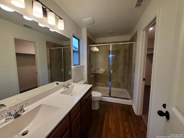 a bathroom with a toilet a sink and mirror