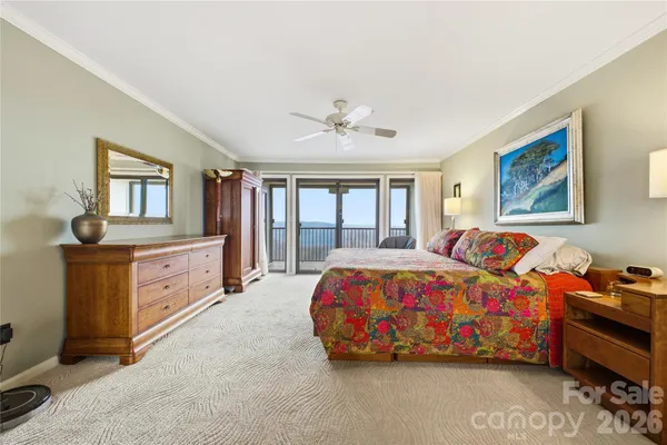 a spacious bedroom with a bed and a dresser