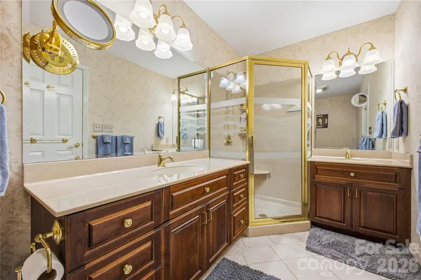 a spacious bathroom with a sink a mirror and a shower