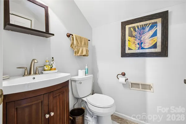 a bathroom with a sink mirror and toilet