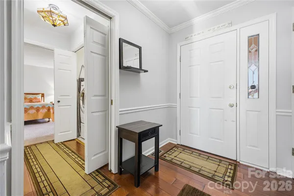 a hallway with table and closet