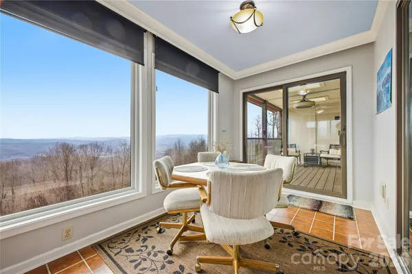 a dining room with furniture a rug and wooden floor