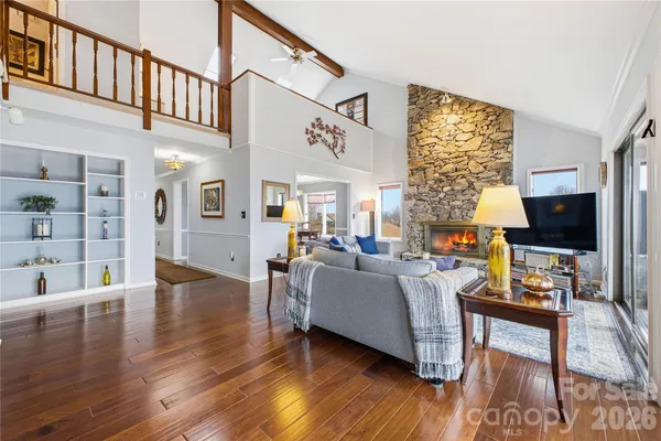 a living room with fireplace furniture and a flat screen tv