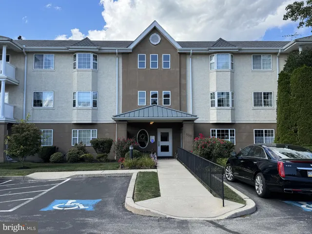 a view of a car parked in front of a brick building