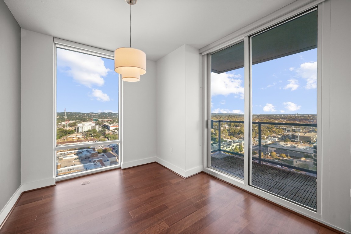 300 Bowie Street, Unit 2405 Austin, TX 78703 - Photo 14 of 39 a view of an empty room with wooden floor and a window