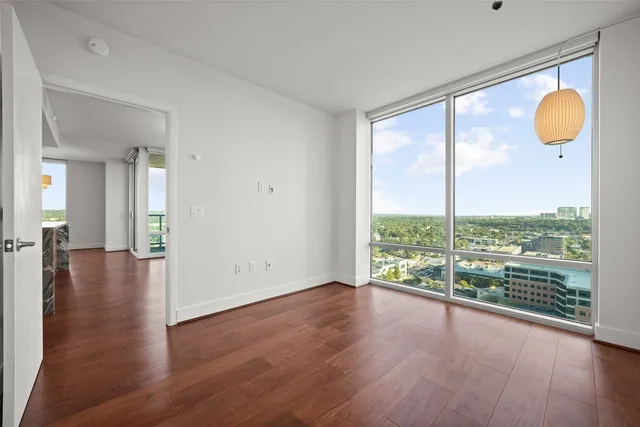 a view of a room with wooden floor and window