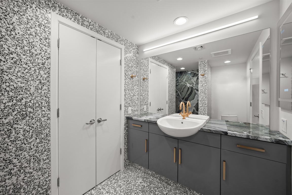 300 Bowie Street, Unit 2405 Austin, TX 78703 - Photo 19 of 39 a bathroom with a sink and a mirror