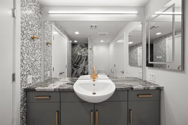 a bathroom with a sink and a mirror