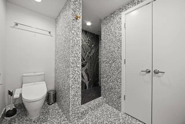 a bathroom with a toilet and shower