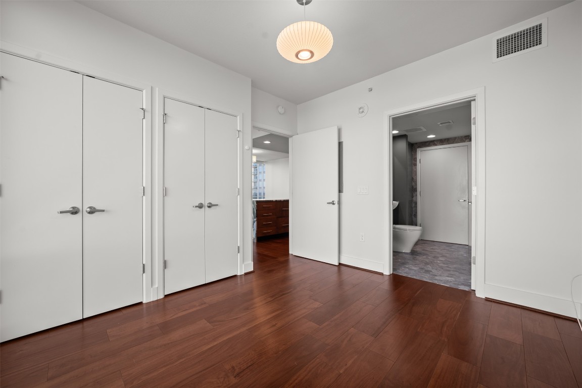300 Bowie Street, Unit 2405 Austin, TX 78703 - Photo 25 of 39 an empty room with wooden floor and a window