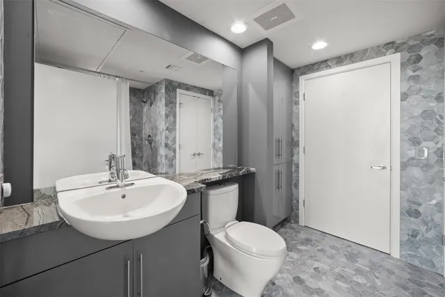 a bathroom with a sink toilet and shower