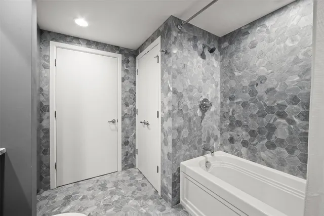 a bathroom with a bathtub and a shower