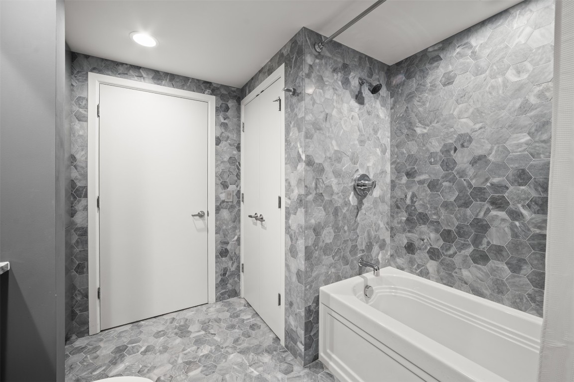 300 Bowie Street, Unit 2405 Austin, TX 78703 - Photo 27 of 39 a bathroom with a bathtub and a shower