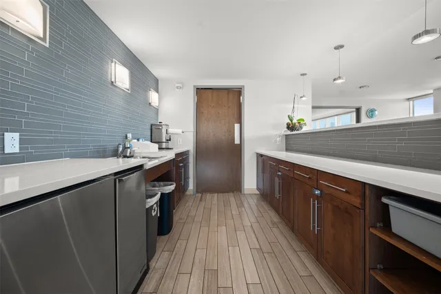 a kitchen with stainless steel appliances granite countertop a sink and wooden cabinets