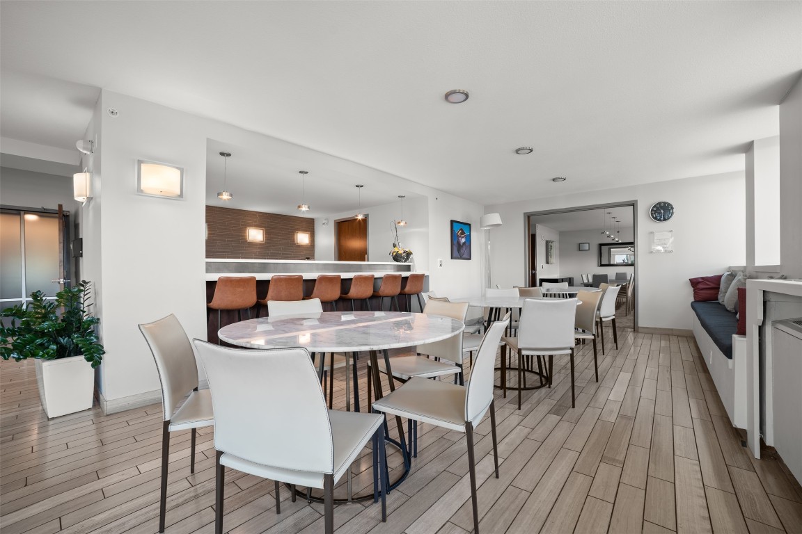 300 Bowie Street, Unit 2405 Austin, TX 78703 - Photo 33 of 39 a view of a dining room with furniture and wooden floor
