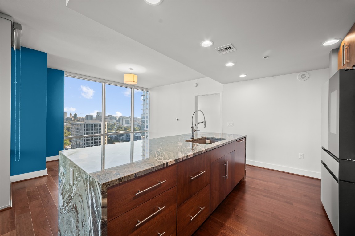 300 Bowie Street, Unit 2405 Austin, TX 78703 - Photo 6 of 39 a room with granite countertop a sink a counter space and stainless steel appliances