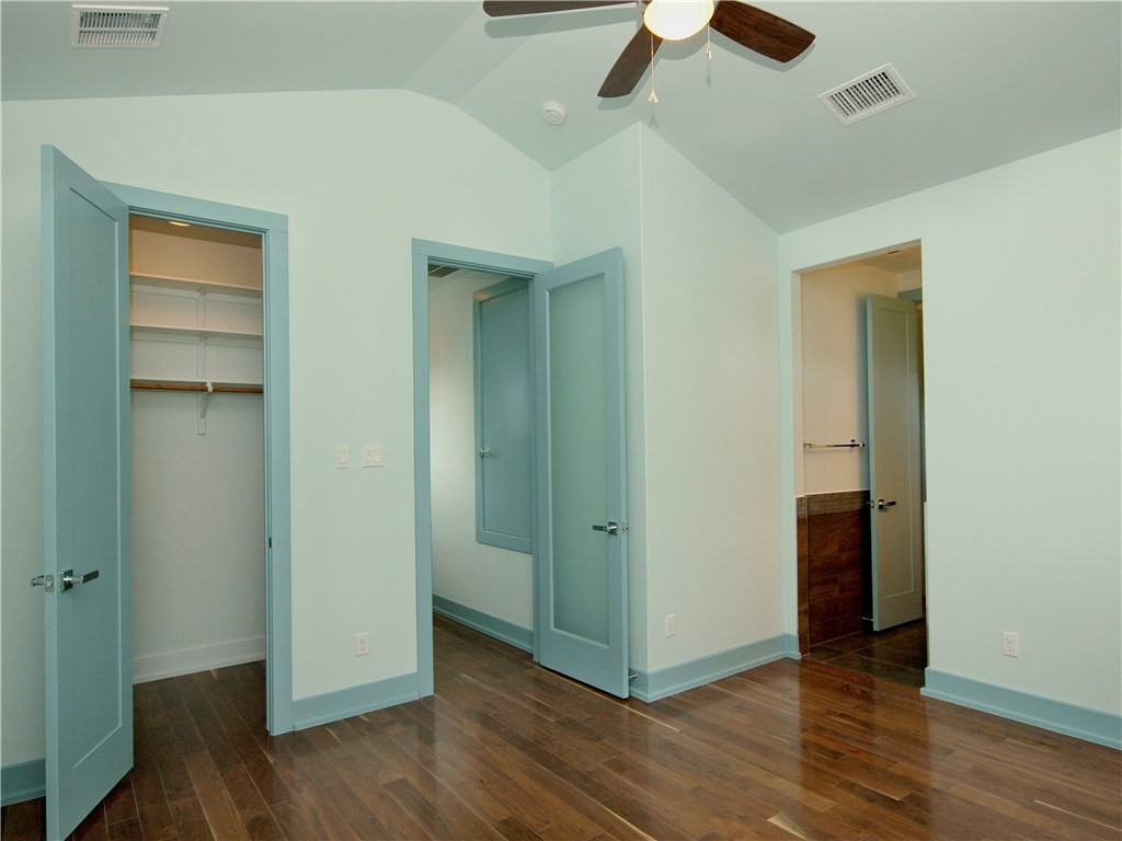 306 Franklin Boulevard, Unit B Austin, TX 78751 - Photo 17 of 23 an empty room with wooden floor closet and windows