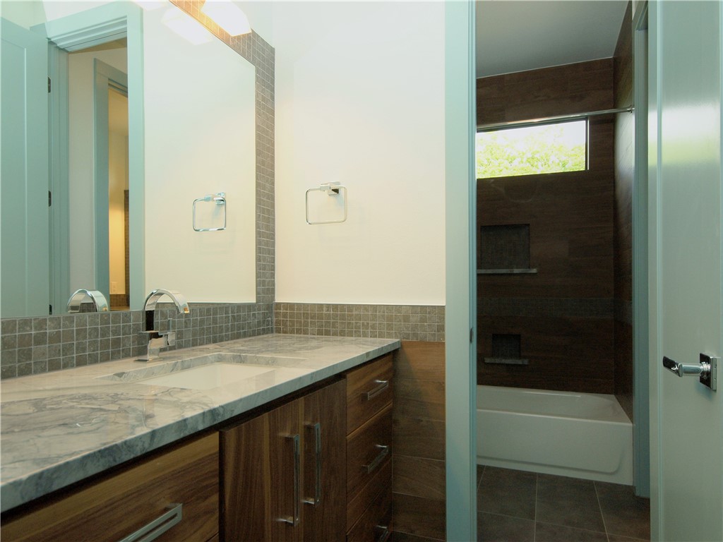 306 Franklin Boulevard, Unit B Austin, TX 78751 - Photo 18 of 23 a bathroom with a granite countertop sink and a mirror