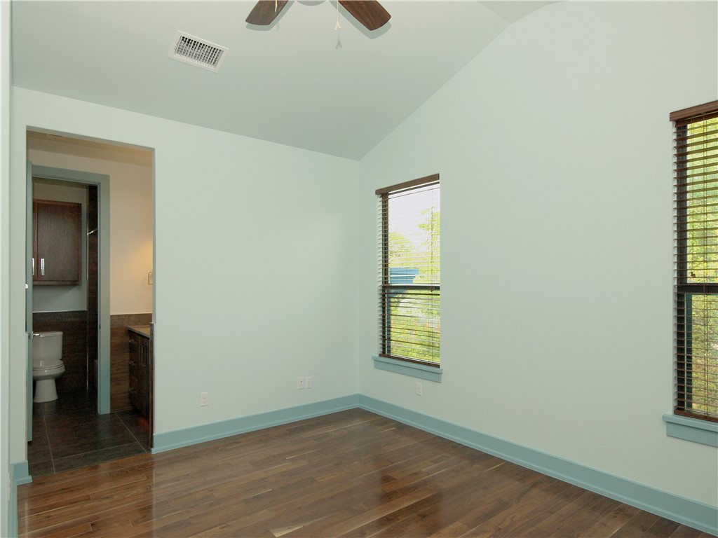 306 Franklin Boulevard, Unit B Austin, TX 78751 - Photo 19 of 23 an empty room with wooden floor closet and windows