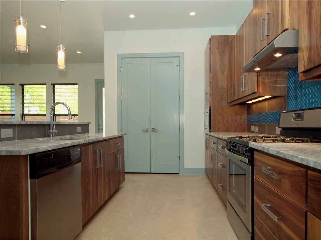 306 Franklin Boulevard, Unit B Austin, TX 78751 - Photo 9 of 23 a kitchen with stainless steel appliances granite countertop a stove a sink and a refrigerator