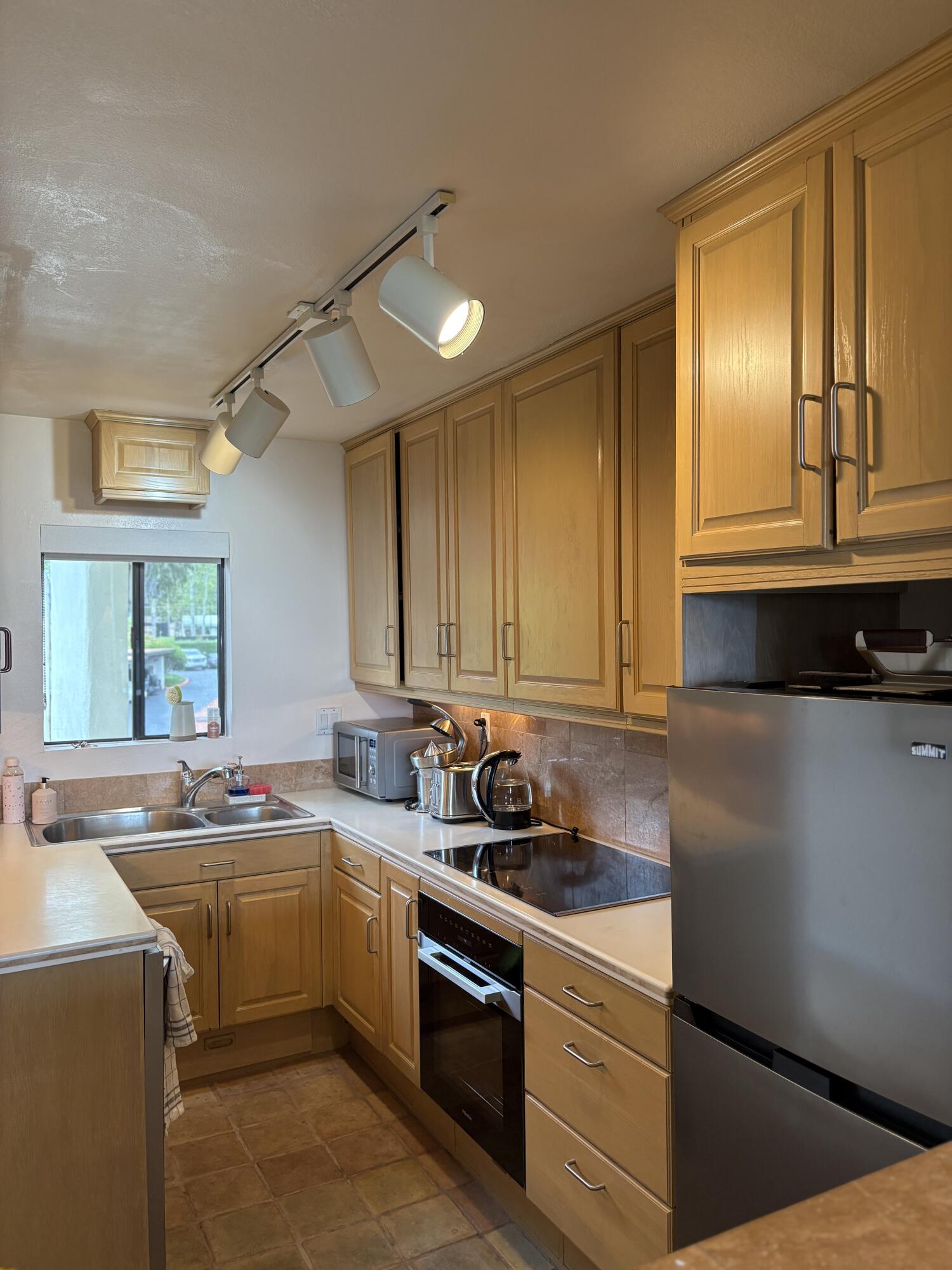 3375 Foothill Road, Unit 533 Carpinteria, CA 93013 - Photo 2 of 12 a kitchen with a sink stove top oven and cabinets