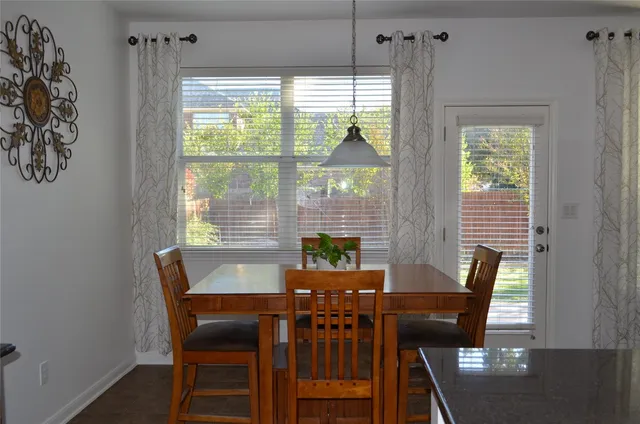 a view of a dining room with furniture and a window