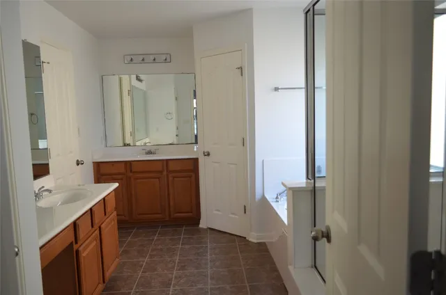 a bathroom with a granite countertop sink a mirror and a
