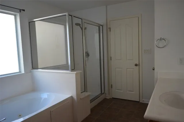 a bathroom with a shower and a sink