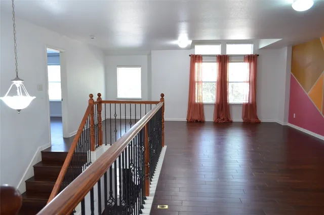 a view of an entryway with wooden floor