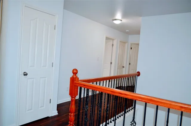 a view of hallway with wooden floor