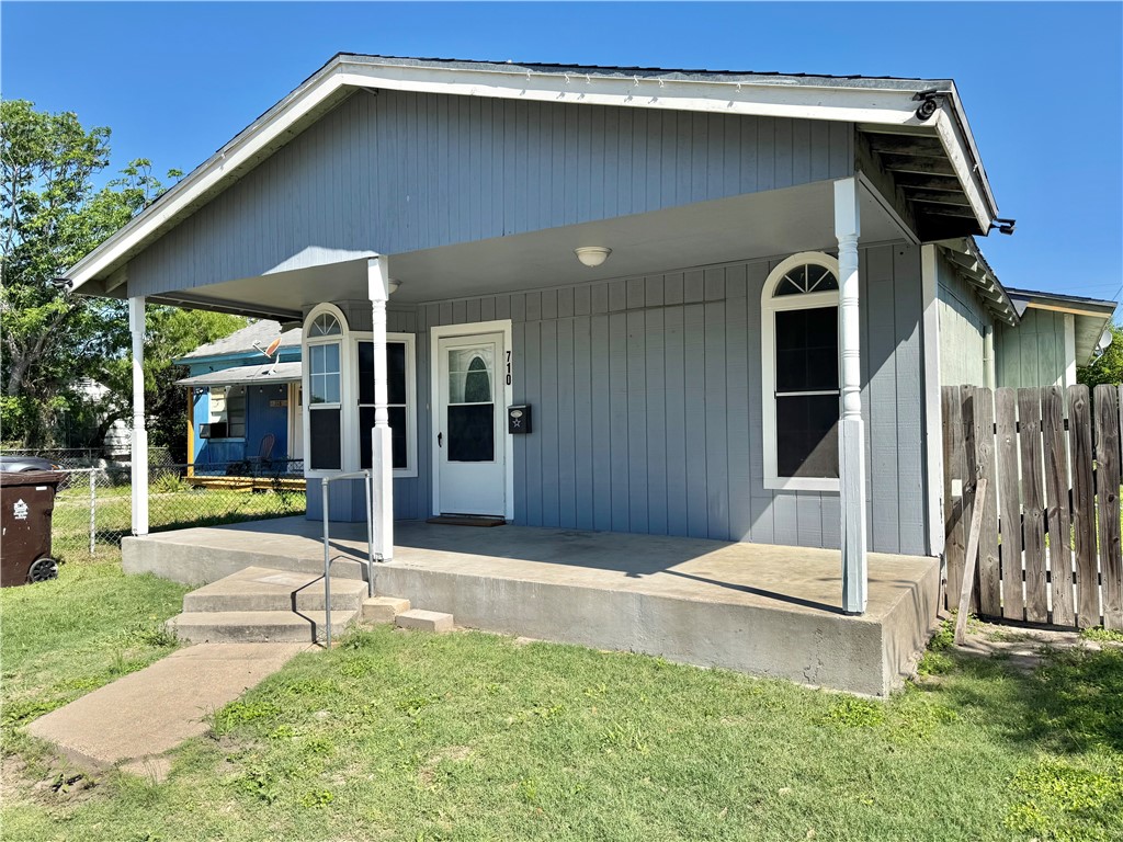 a backyard of a house with yard and outdoor seating