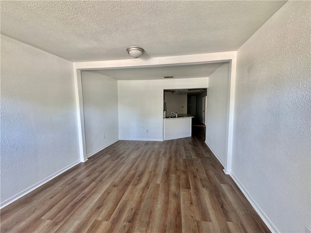 710 East C Avenue Kingsville, TX 78363 - Photo 3 of 13 a view of a room with wooden floor and natural light