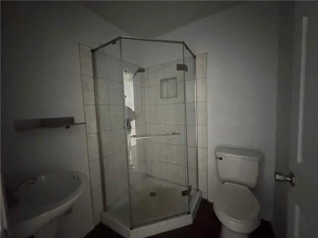 a bathroom with a shower and a toilet