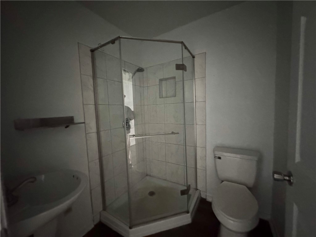 710 East C Avenue Kingsville, TX 78363 - Photo 5 of 13 a bathroom with a shower and a toilet