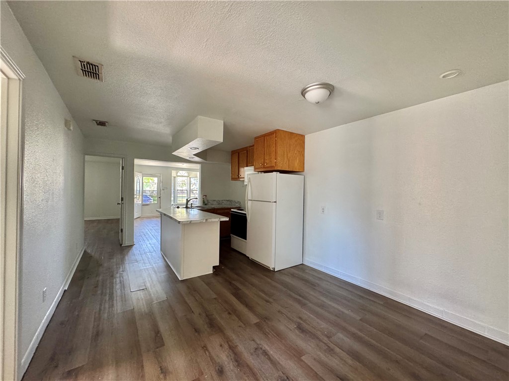 710 East C Avenue Kingsville, TX 78363 - Photo 7 of 13 a view of kitchen and dining room with wooden floor