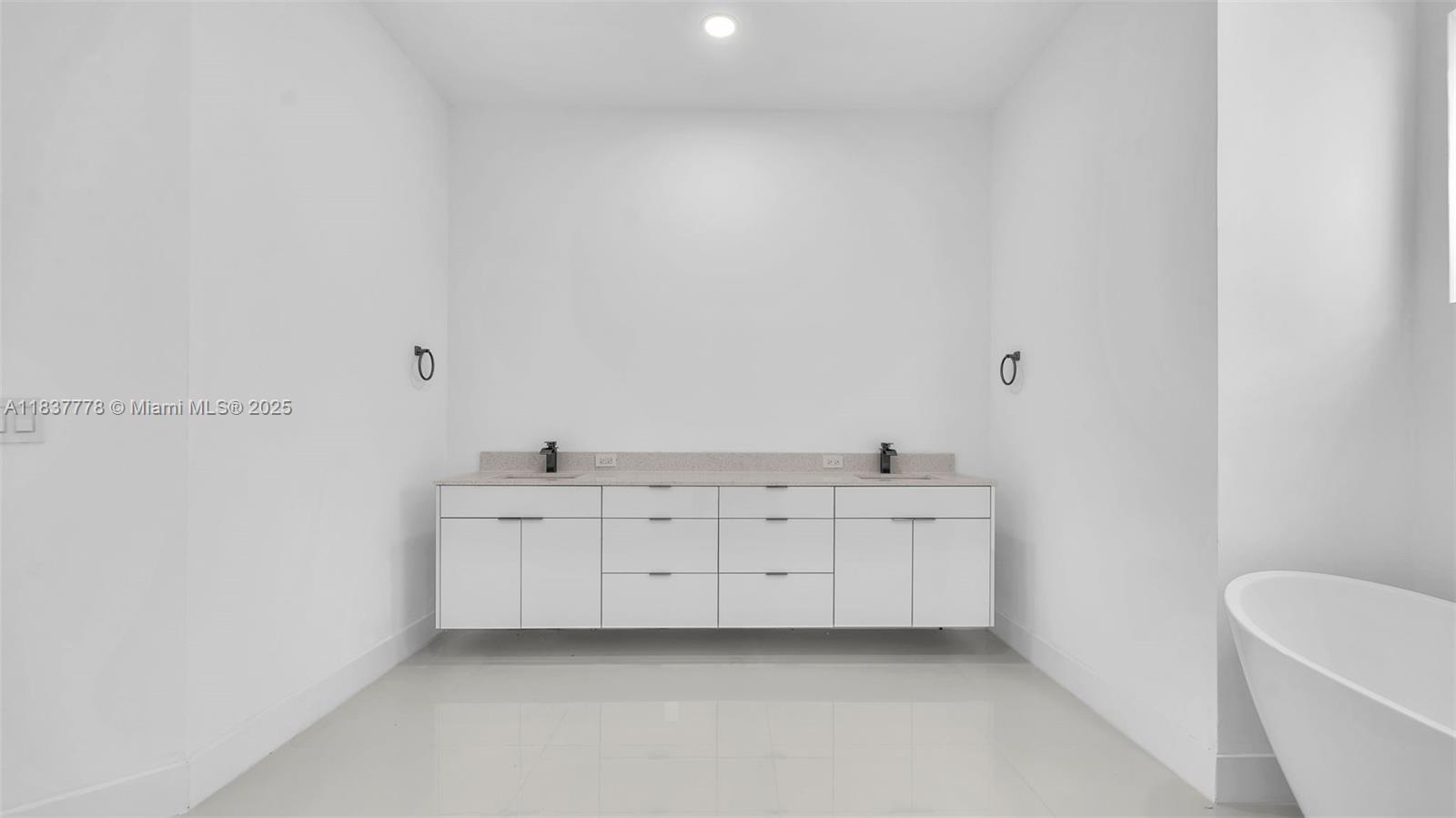 23120 Southwest 154th Court Miami, FL 33170 - Photo 33 of 51 a room with white cabinets and sink