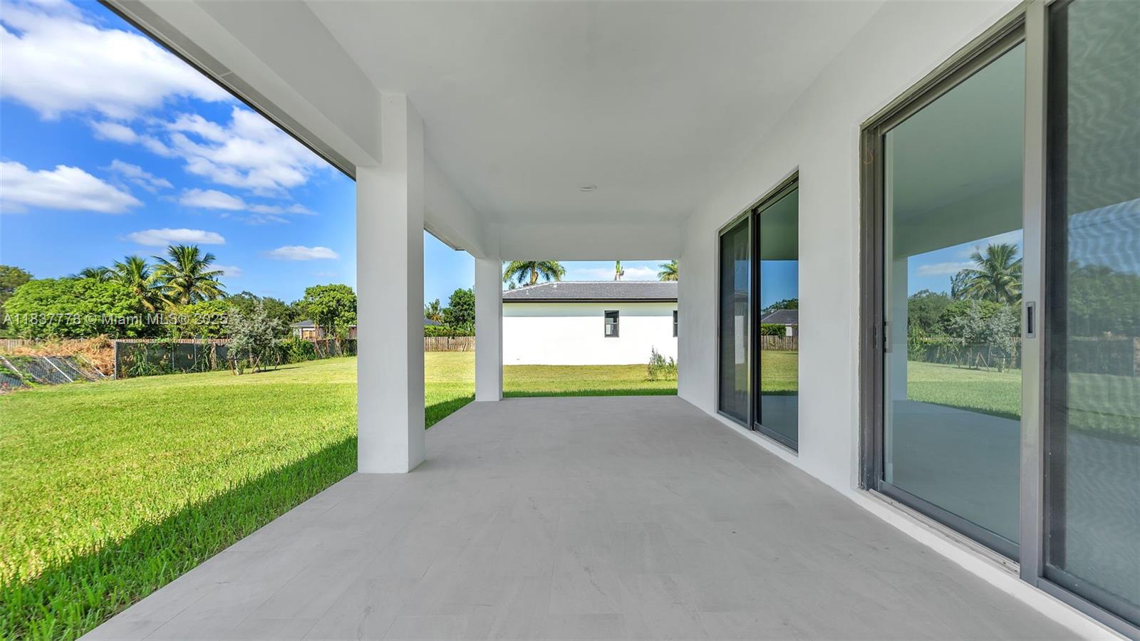 23120 Southwest 154th Court Miami, FL 33170 - Photo 44 of 51 a view of a room with floor to ceiling windows and yard
