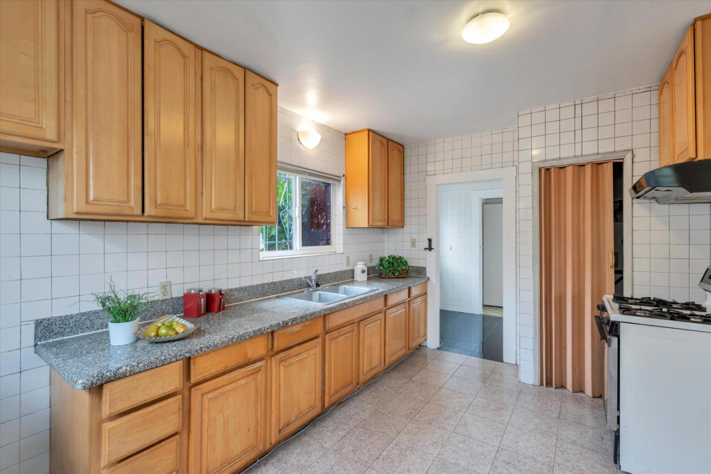 1904 Blake Street Berkeley, CA 94704 - Photo 11 of 24 a kitchen with stainless steel appliances granite countertop a sink stove and refrigerator