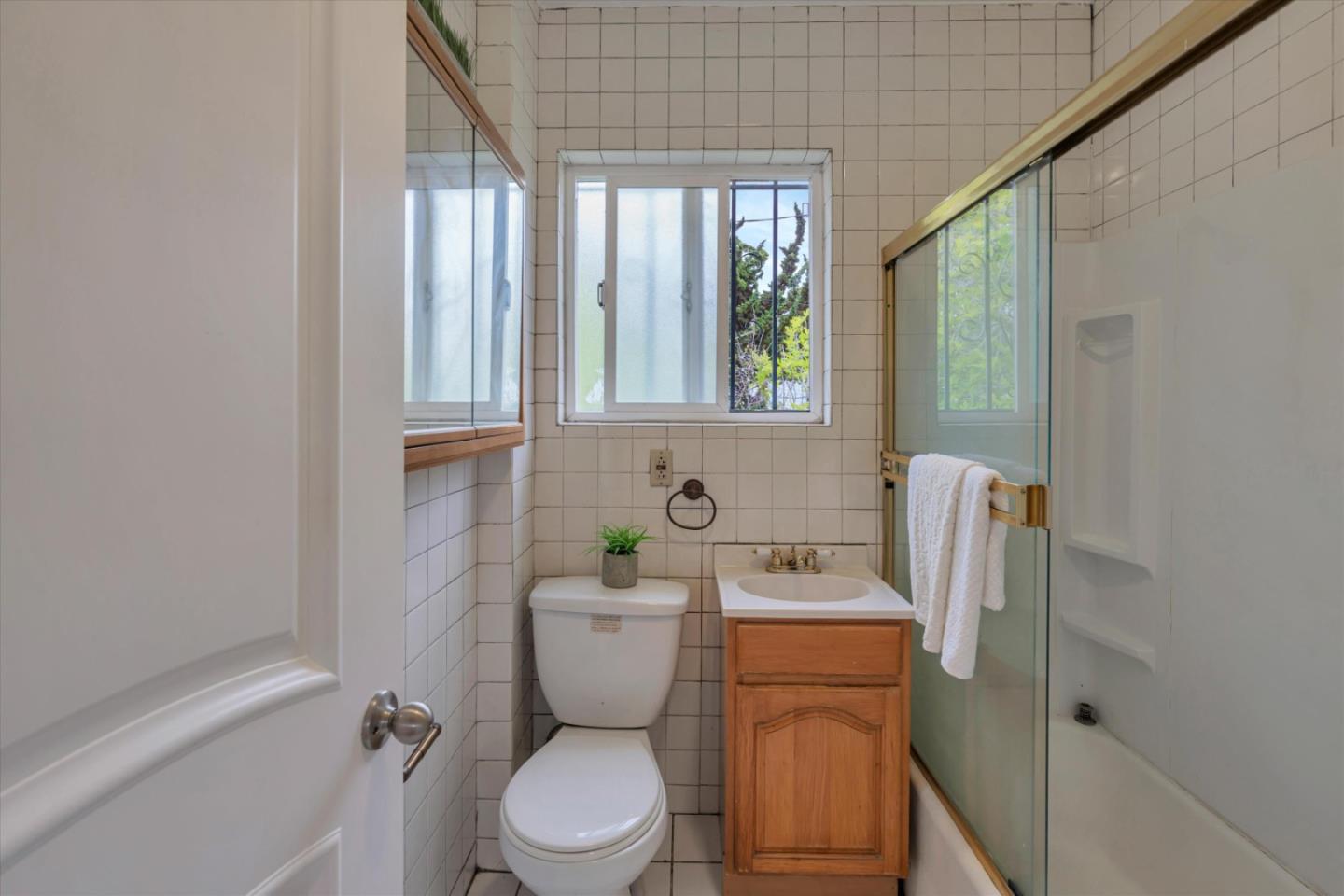 1904 Blake Street Berkeley, CA 94704 - Photo 14 of 24 a bathroom with a toilet sink and mirror