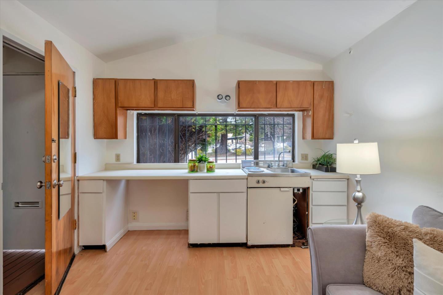 1904 Blake Street Berkeley, CA 94704 - Photo 20 of 24 a kitchen with stainless steel appliances white cabinets and wooden floor