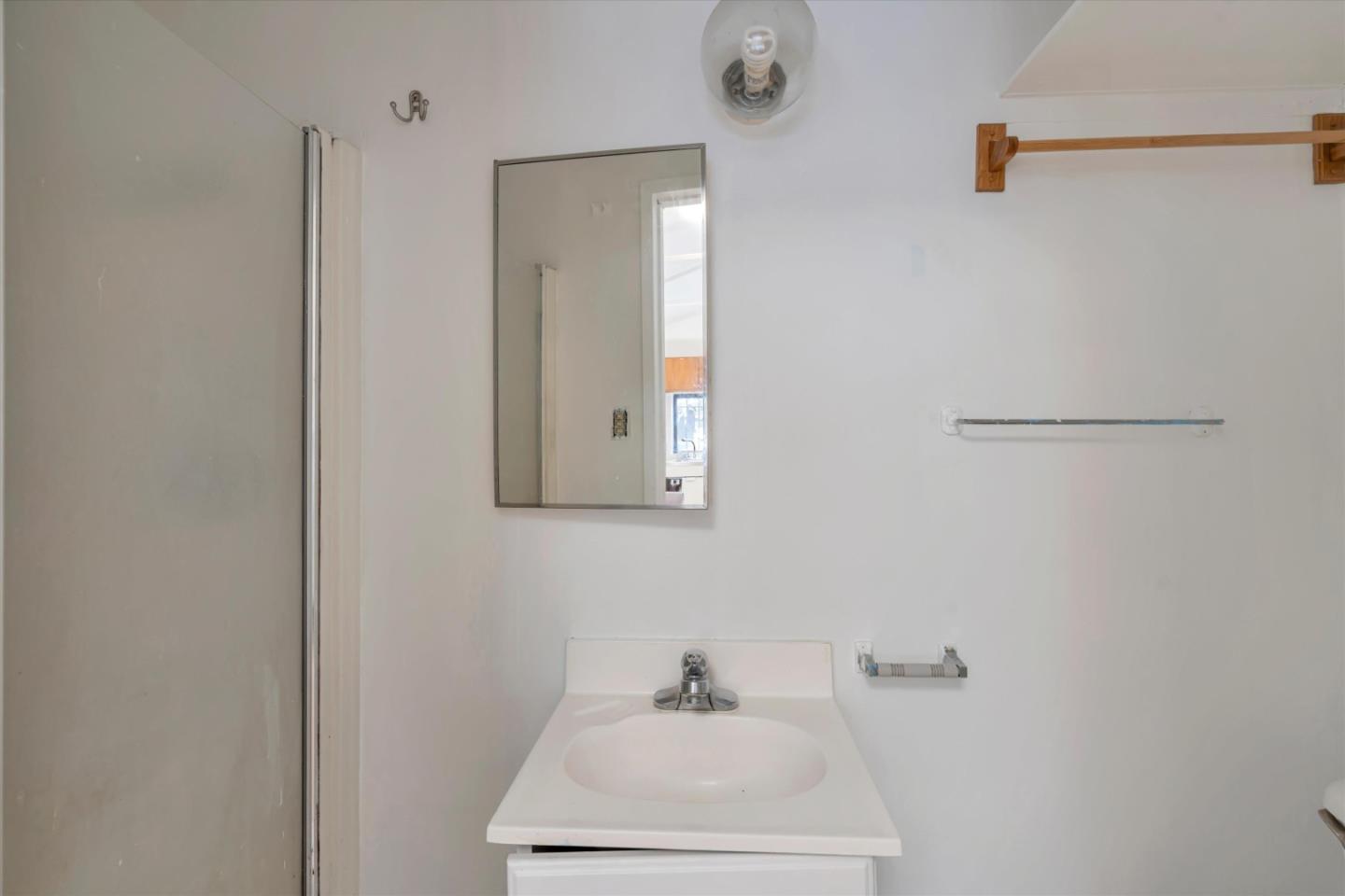 1904 Blake Street Berkeley, CA 94704 - Photo 22 of 24 a bathroom with a sink a mirror and vanity