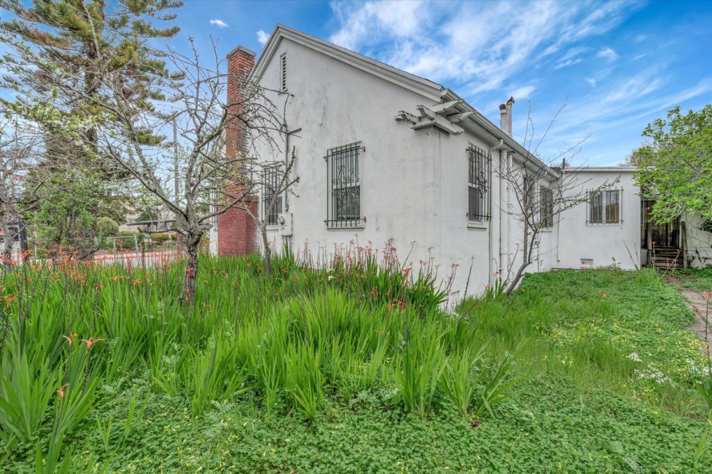1904 Blake Street Berkeley, CA 94704 - Photo 24 of 24 a view of a white house with a big yard and large tree