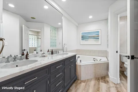 a white toilet sitting next to a bathroom sink