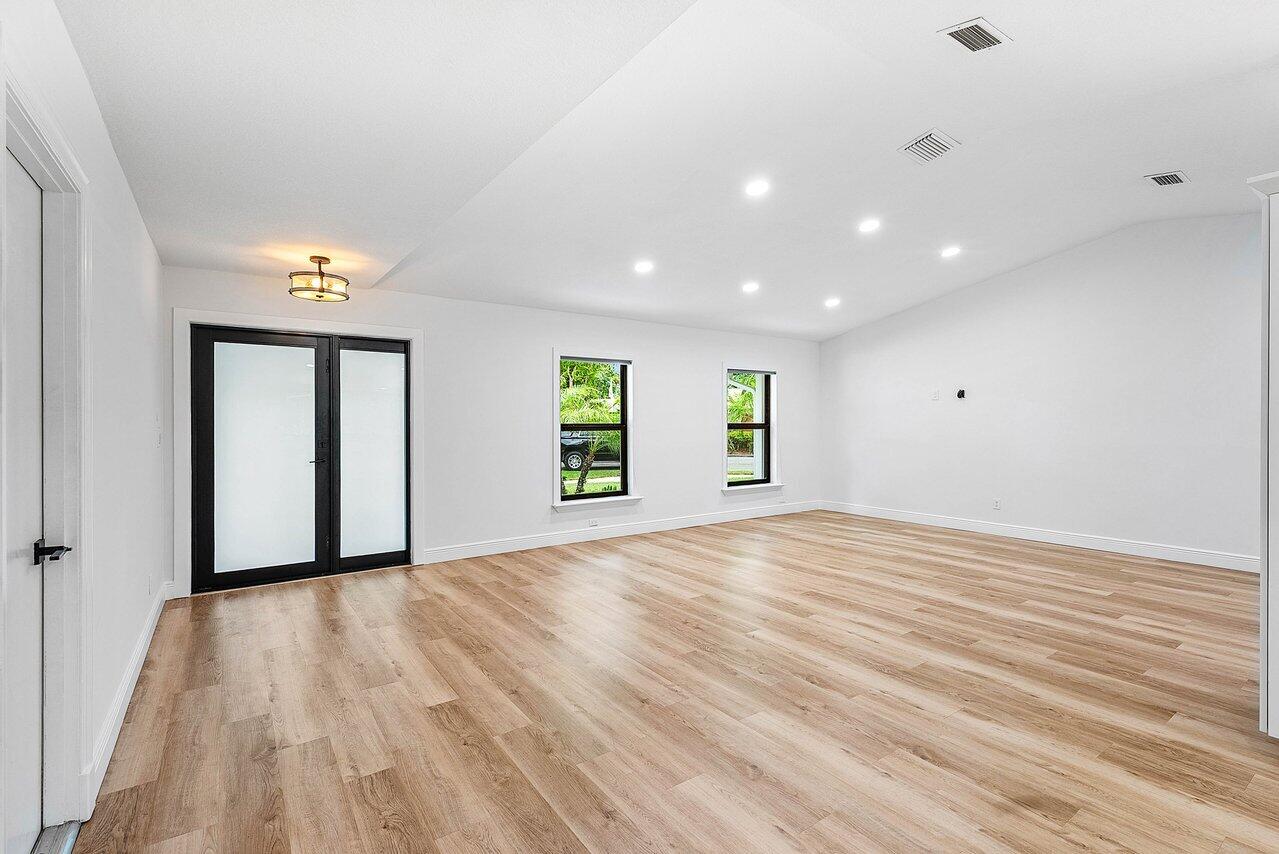 2425 Northwest 36th Street Boca Raton, FL 33431 - Photo 2 of 31 a view of an empty room with wooden floor and a window