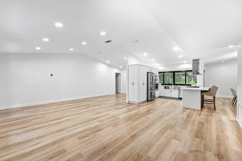 a view of a kitchen with a table and chairs