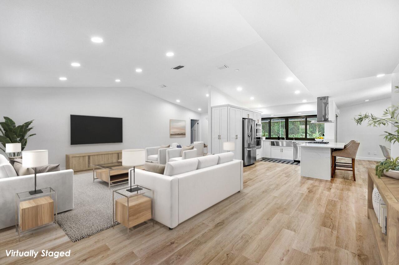 2425 Northwest 36th Street Boca Raton, FL 33431 - Photo 5 of 31 a living room with furniture wooden floor and a flat screen tv