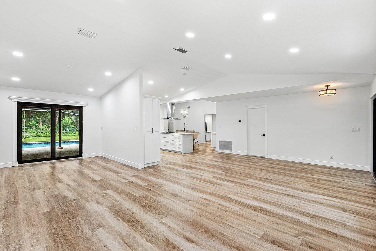 2425 Northwest 36th Street Boca Raton, FL 33431 - Photo 6 of 31 a view of an empty room with wooden floor and a window